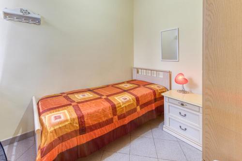 a bedroom with a bed and a dresser and a mirror at Baia del Mare in Lido Marini