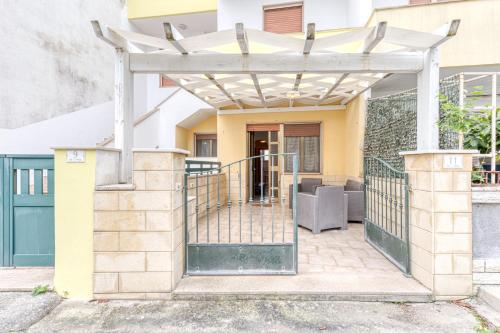 a pergola over a gate to a house at Baia del Mare in Lido Marini