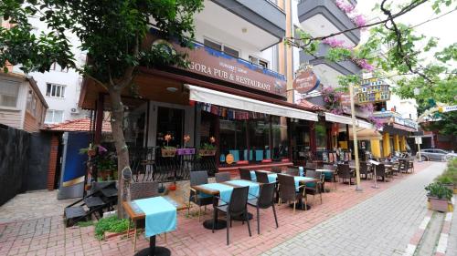 a street with tables and chairs on a sidewalk at Agora Boutique Apart Hotel in Alanya
