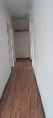an empty hallway with wood floors and a closet at Dawn Park Guest House in Boksburg