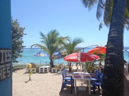 聖弗朗西斯的住宿－CABANE au Soleil by，海滩上的桌椅和遮阳伞