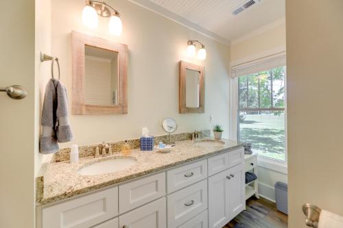 a bathroom with two sinks and a window at New Bern Vacation Rental on Farm with Fire Pit! in New Bern
