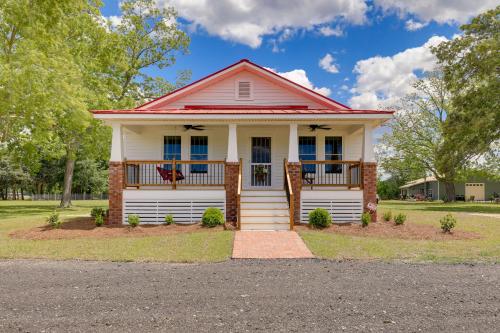 a white house with a red roof at New Bern Vacation Rental on Farm with Fire Pit! in New Bern