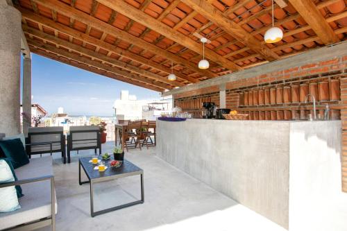 an outdoor entertaining area with a bar and tables at Casitas Miramar Puerto Vallarta Malecón in Puerto Vallarta