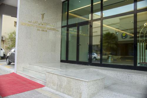 a building with a bench in front of a building at Infinity Tower Suites WLL in Manama