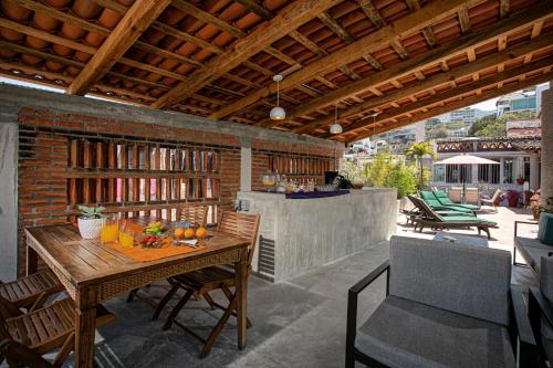 a patio with a wooden table with fruit on it at Casitas Miramar Puerto Vallarta Malecón in Puerto Vallarta