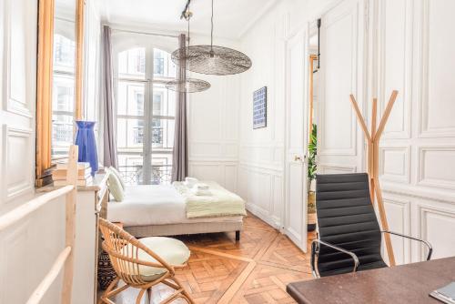 Zimmer mit einem Bett, einem Tisch und Stühlen in der Unterkunft Outstanding Parisian flat in heart of Paris center in Paris