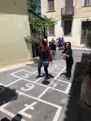 two women playing hopscotch in a street at ARIS Piraeus- Sailor's friend in Piraeus