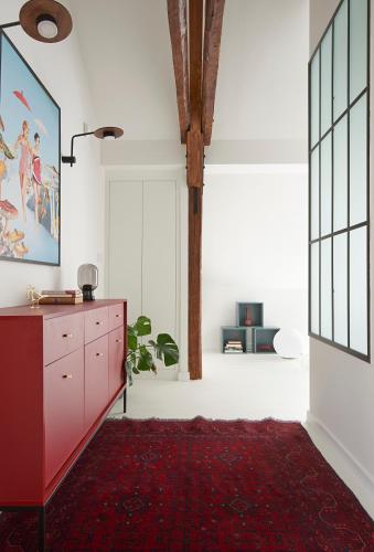 a living room with a red dresser and a red rug at Villa Chez les Amis - Adults only in Balatonszepezd