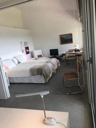 a bedroom with a bed and a table and chairs at LA CODORNIZ in Villaviciosa