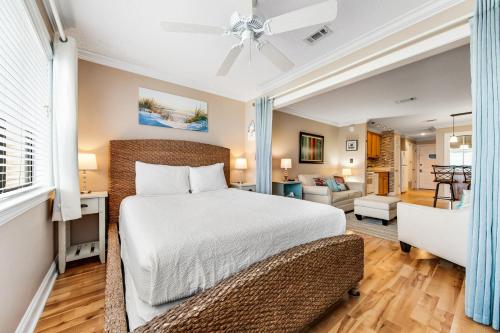 a bedroom with a bed and a living room at Sunset Harbor Palms 1-311 in Navarre
