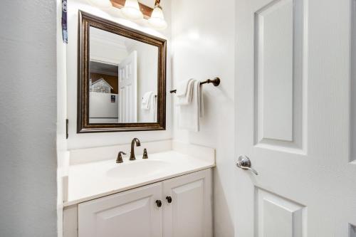 a white bathroom with a sink and a mirror at Sunset Harbor Palms 1-311 in Navarre