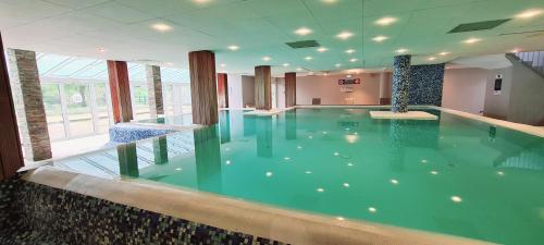 a large swimming pool in a building at Résidence Goélia Les Gorges de la Truyère in Entraygues-sur-Truyère