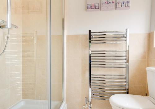 a bathroom with a shower and a toilet at Keepers Cottage in East Dereham