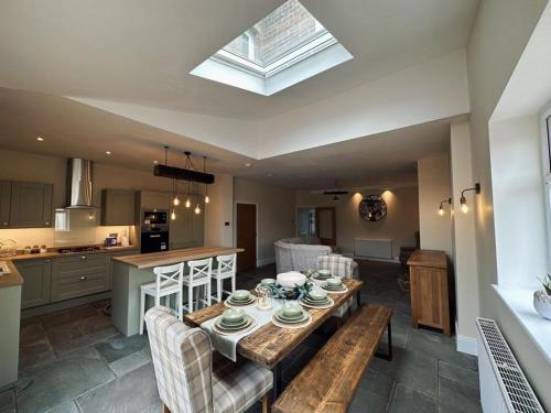 a kitchen and a living room with a table and chairs at The Old Station House by Holiday Heim in Lytham St Annes