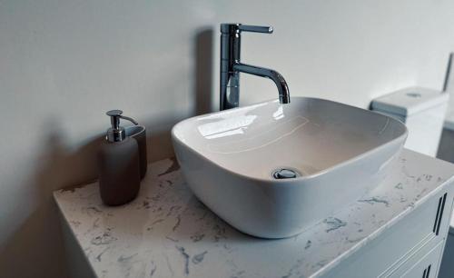 a white sink on a counter in a bathroom at The Old Station House by Holiday Heim in Lytham St Annes