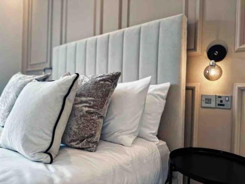 a white couch with pillows on top of it at The Old Station House by Holiday Heim in Lytham St Annes