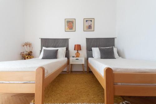 two beds sitting next to each other in a bedroom at Porto Albona in Rabac