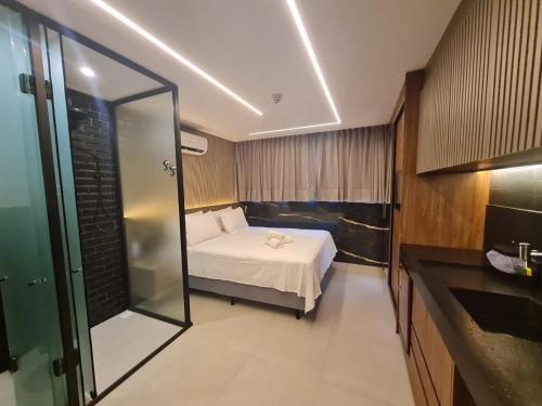 a hotel room with a bed and a mirror at Get One - Bessa in Tambaú