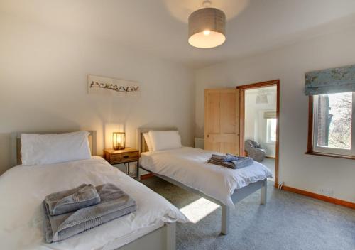 Posteľ alebo postele v izbe v ubytovaní Lilac Cottage