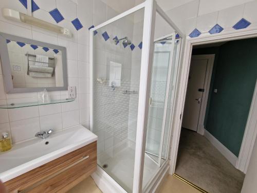 a bathroom with a shower and a sink at The Portland Hotel in Folkestone