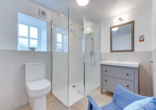 a bathroom with a toilet and a shower and a sink at Little Barn in Upton