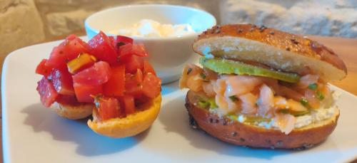 a sandwich on a plate with a bowl of vegetables at Palazzo Muro Leccese Relais de Charme & Wellness in Muro Leccese