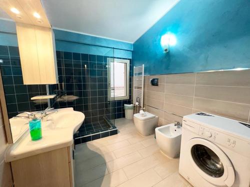 a bathroom with a sink and a washing machine at Apartment TAORMINA center with TERRACE, via Celestino Penna 6 in Taormina