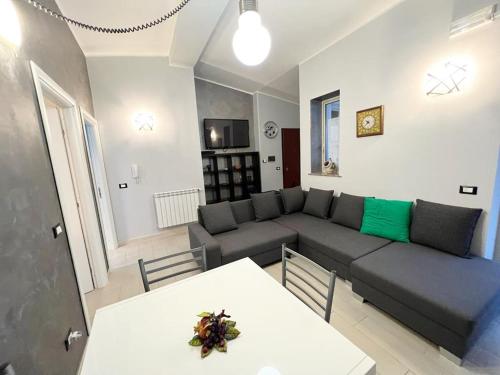 a living room with a couch and a table at Apartment TAORMINA center with TERRACE, via Celestino Penna 6 in Taormina