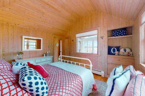 a bedroom with a bed and a wooden ceiling at Birds Nest in Blue Hill