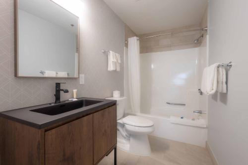 a bathroom with a sink and a toilet at Westborough Inn in Westborough