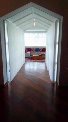 an empty living room with a couch and a table at Center Suiço Flats in Campos do Jordão