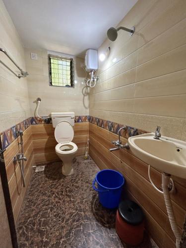 a bathroom with a toilet and a sink at Shobha Niwas in Nandgaon