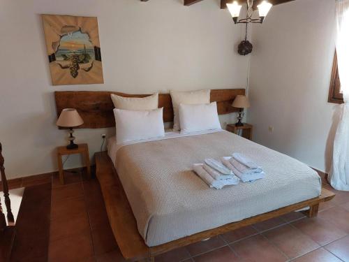 a bedroom with a bed with two towels on it at Petrino in Rhodes Town