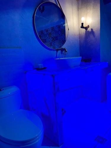 a blue bathroom with a sink and a mirror at Blue Tulip - 4mins from Mactan Airport in Pusok