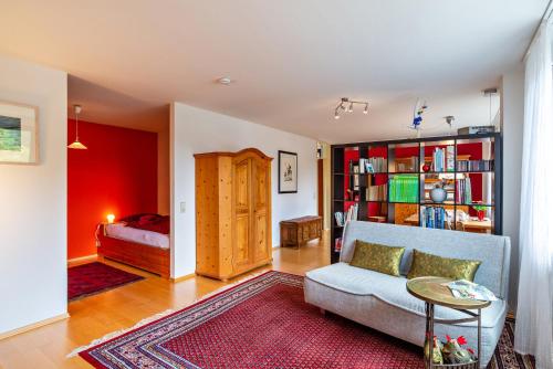 a living room with a couch and a bedroom at Ferienwohnung Fasse in Bühlertal