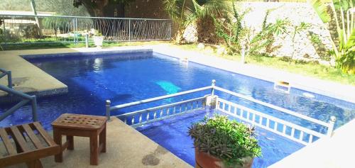 a swimming pool with blue water in a yard at DALDIAM in Ngaparou