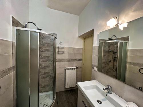 uma casa de banho com uma cabina de duche em vidro e um lavatório. em Cuor di Maria em Agerola