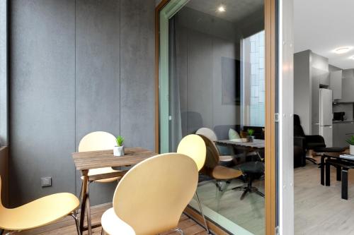 a dining room with yellow chairs and a table at Tower Apartments in Reykjavík