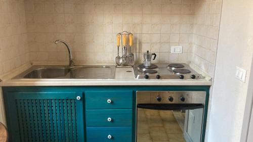 a kitchen with a sink and a stove at La Mattanza in Trapani
