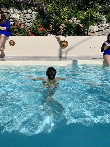 a person swimming in a swimming pool at HOTEL MERCURIO SUL MARE - Fish restaurant and private beach in Capo Vaticano