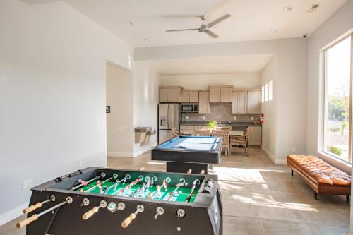 a large living room with a pool table at The Pad Spacious Luxury Retreat Sleeps 23, Private Pool, Spa, Game Room and More in Hurricane