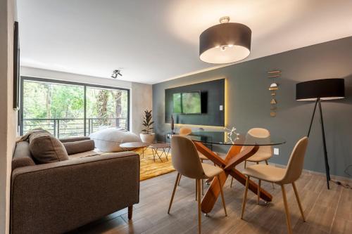 a living room with a couch and a table at Parque España 21 by Wynwood House in Mexico City