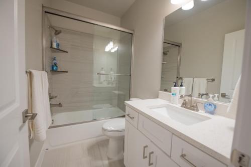 a bathroom with a sink and a toilet and a shower at The Pad Spacious Luxury Retreat Sleeps 23, Private Pool, Spa, Game Room and More in Hurricane
