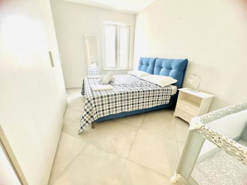 a bedroom with a blue bed and a window at Suite LEI - Sanremo in Sanremo