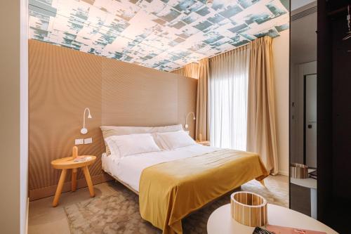 a hotel room with a bed and a coffered ceilings at Biancodonda Lifestyle Hotel & SPA in Gallipoli