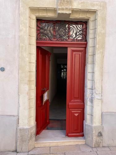 a red door in a building with a red frame at JOHA DOMA in Lunel