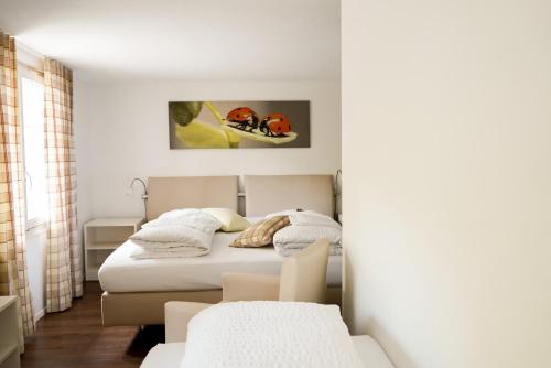 a bedroom with a bed in a room at Seehotel Baumgarten in Kehrsiten