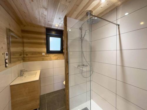 a bathroom with a shower and a sink at Le Refuge perché du saut de la bourrique SPA Gérardmer in Gérardmer