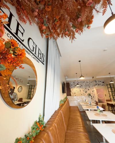 a restaurant with tables and a mirror on the wall at The Gibs Hotel Limited in Port Harcourt